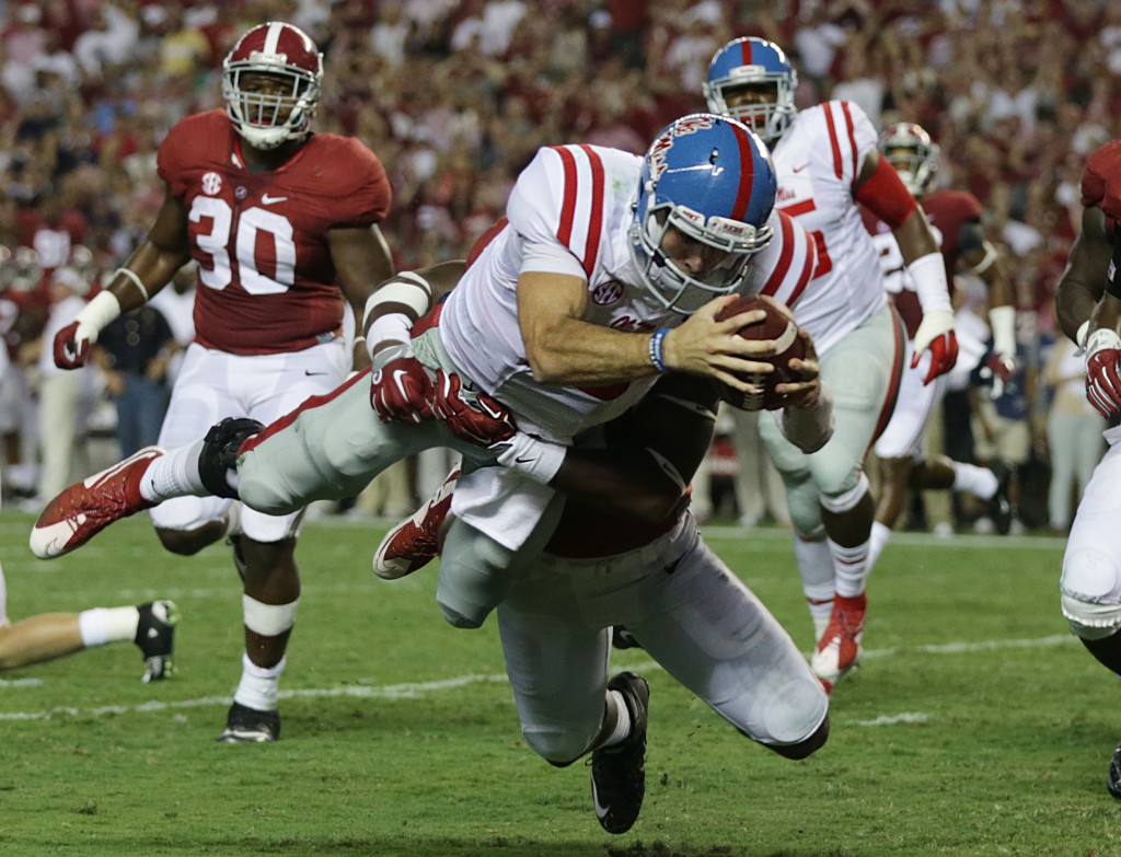 FILE - In this Sept. 19, 2015, file photo, Mississippi quarterback Chad Kelly dives in for a touchdown past Alabama linebacker Shaun Hamilton during first half of an NCAA college football game in Tuscaloosa, Ala. After leading East Mississippi Community College to a national title, Kelly transferred to Ole Miss, where he is ranked second nationally in passing efficiency. (AP Photo/Butch Dill, File)
