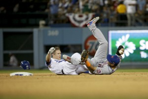 New York Mets shortstop Ruben Tejada, right, lands next to Los Angeles Dodgers' Chase Utley who broke up a double play during the seventh inning in Game 2 of baseball's National League Division Series, Saturday, Oct. 10, 2015 in Los Angeles. (AP Photo/Gregory Bull)