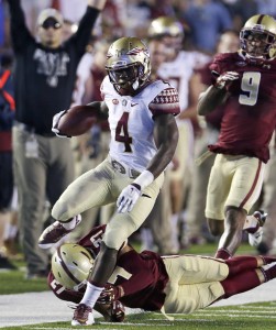 FILE - In this Sept. 18, 2015, file photo, Florida State running back Dalvin Cook (4) tries to outrun Boston College defensive back Justin Simmons (27) and defensive back John Johnson (9) during the first half of an NCAA college football game in Boston. Florida State's Dalvin Cook and Miami's Joseph Yearby are the top two running backs in the Atlantic Coast Conference who once shared the same backfield at Miami Central High School. (AP Photo/Charles Krupa, File)