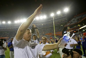 Florida head coach Jim McElwain celebrates with the gator chomp in front of fans after defeating New Mexico State 61-13 in an NCAA college football game, Saturday, Sept. 5, 2015, in Gainesville, Fla. (AP Photo/John Raoux)