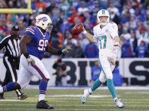 Nov 8, 2015; Orchard Park, NY, USA; Buffalo Bills defensive tackle Marcell Dareus (99) chases Miami Dolphins quarterback Ryan Tannehill (17) out of the pocket during the second half at Ralph Wilson Stadium. The Bills beat the Dolphins 33-17. Mandatory Credit: Kevin Hoffman-USA TODAY Sports
