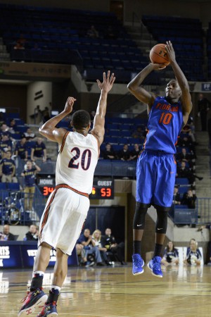 Nov 13, 2015; Annapolis, MD, USA; Florida Gators forward Dorian Finney-Smith (10) shoots over Navy Midshipmen guard Shawn Anderson (20) during the second half of the Veterans Classic at Alumni Hall. Florida Gators defeated Navy Midshipmen 59-41. Mandatory Credit: Tommy Gilligan-USA TODAY Sports