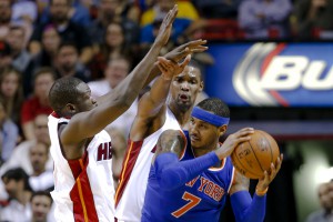 Nov 23, 2015; Miami, FL, USA; New York Knicks forward Carmelo Anthony (right) is pressured by Miami Heat forward Luol Deng (left) and Miami Heat forward Chris Bosh (center) during the second half at American Airlines Arena. The Heat won 95-78. Mandatory Credit: Steve Mitchell-USA TODAY Sports