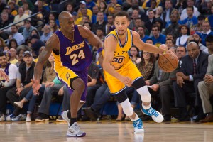 Golden State Warriors guard Stephen Curry (30) dribbles the basketball against Los Angeles Lakers forward Kobe Bryant (24) during the third quarter at Oracle Arena. The Warriors defeated the Lakers 111-77. Mandatory Credit: Kyle Terada-USA TODAY Sports