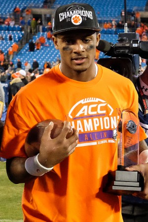 Dec 5, 2015; Charlotte, NC, USA; Clemson Tigers quarterback Deshaun Watson (4) walks off the field with the MVP trophy after the ACC football championship game at Bank of America Stadium. The Tigers won 45-37. Mandatory Credit: Jim Dedmon-USA TODAY Sports