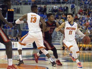Jan 2, 2016; Gainesville, FL, USA; Florida Gators guard Chris Chiozza (11) dribbles the ball as Georgia Bulldogs guard Kenny Gaines (12) defends in the first half at Stephen C. O'Connell Center. Mandatory Credit: Logan Bowles-USA TODAY Sports