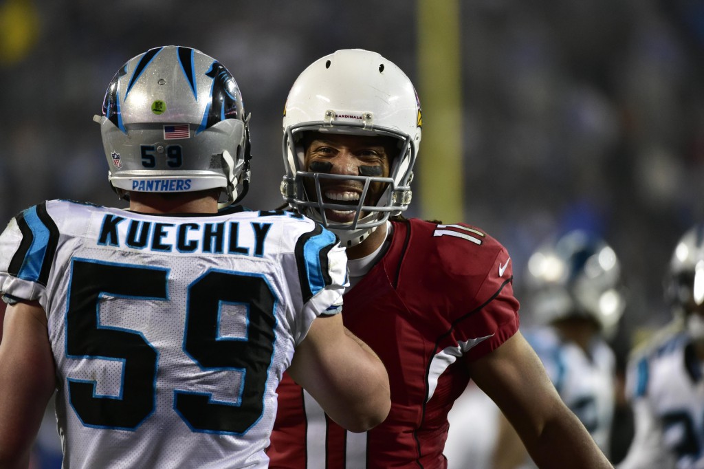 Jan 3, 2015; Charlotte, NC, USA; Arizona Cardinals wide receiver Larry Fitzgerald (11) talks to Carolina Panthers middle linebacker Luke Kuechly (59) during the second quarter in the 2014 NFC Wild Card playoff football game at Bank of America Stadium. Mandatory Credit: Bob Donnan-USA TODAY Sports