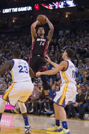 January 11, 2016; Oakland, CA, USA; Miami Heat forward Gerald Green (14) shoots the basketball against Golden State Warriors forward Draymond Green (23) and guard Klay Thompson (11) during the second quarter at Oracle Arena. Mandatory Credit: Kyle Terada-USA TODAY Sports