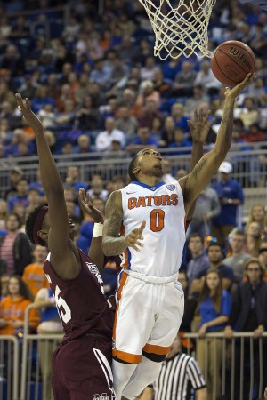 Jan 19, 2016; Gainesville, FL, USA; Florida Gators guard Kasey Hill (0) takes a shot as Mississippi State Bulldogs forward Aric Holman (right) defends in the second half at Stephen C. O'Connell Center. The Florida Gators won 81-78. Mandatory Credit: Logan Bowles-USA TODAY Sports