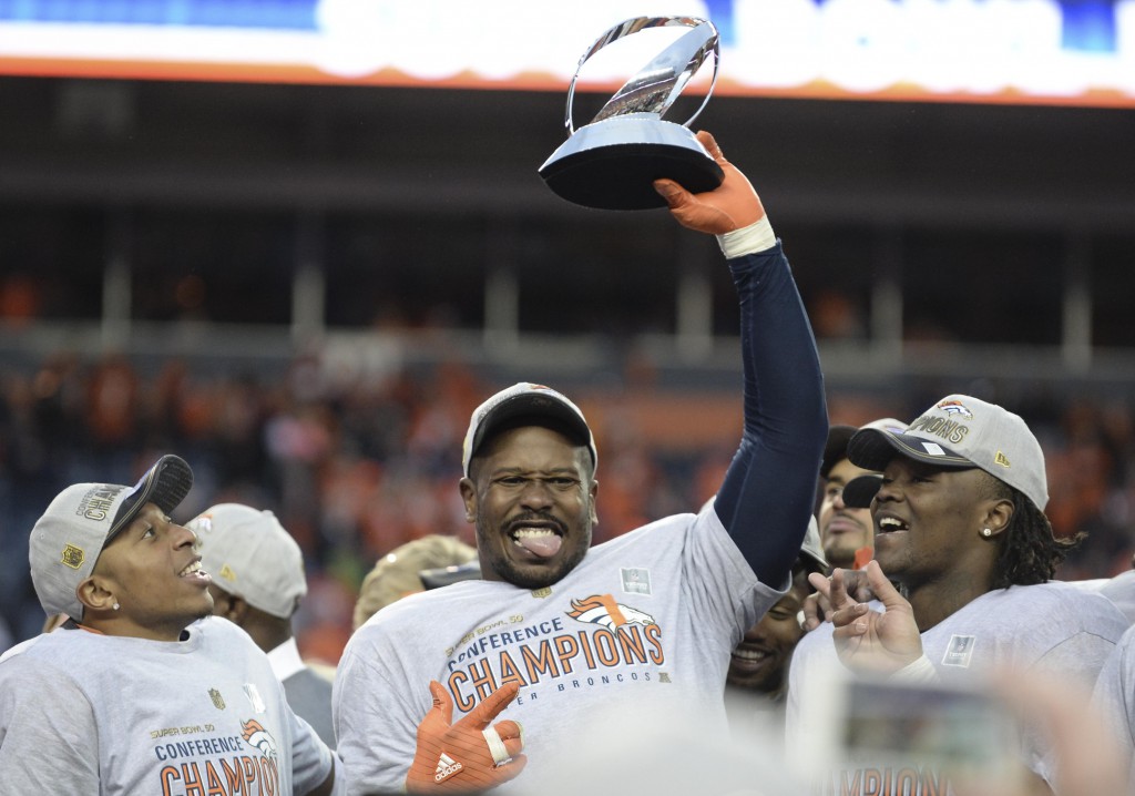 Jan 24, 2016; Denver, CO, USA; Denver Broncos outside linebacker Von Miller (58) celebrates with the Lamar Hunt Trophy after the AFC Championship football game at Sports Authority Field at Mile High. Denver Broncos defeated New England Patriots 20-18 to earn a trip to Super Bowl 50. Mandatory Credit: Ron Chenoy-USA TODAY Sports