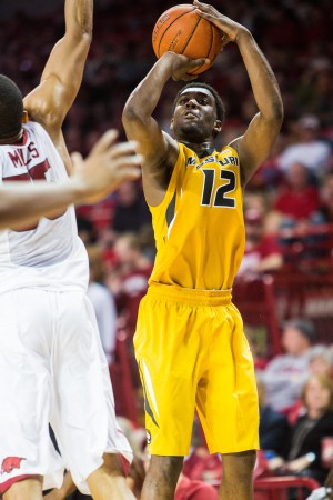 Feb 20, 2016; Fayetteville, AR, USA; Missouri Tigers guard Namon Wright (12) takes a shot as Arkansas Razorbacks forward Keaton Miles (55) defends in the second half at Bud Walton Arena. The Razorbacks won 84-72. Mandatory Credit: Gunnar Rathbun-USA TODAY Sports