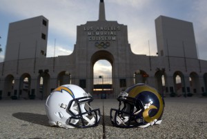 Mar 4, 2016; Los Angeles, CA, USA; General view of Los Angeles Rams and San Diego Chargers helmets and the Olympic torch at the peristyle end of the Los Angeles Memorial Coliseum. The Coliseum will serve as the temporary home of the Rams after NFL owners voted 30-2 to allow Rams owner Stan Kroenke (not pictured) to relocate the franchise for the 2016 season. Chargers owner Dean Spanos (not pictured) has an option to join the Rams in Los Angeles. Mandatory Credit: Kirby Lee-USA TODAY Sports