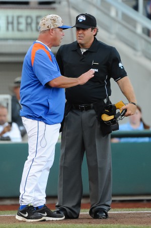 Jun 20, 2015; Omaha, NE, USA; Florida Gators head coach Kevin O'Sullivan talks with the umpire after his batter is called back to the plate after the umpires rules he did not try to avoid a pitch in the second inning against the Virginia Cavaliers in the 2015 College World Series at TD Ameritrade Park. Mandatory Credit: Steven Branscombe-USA TODAY Sports