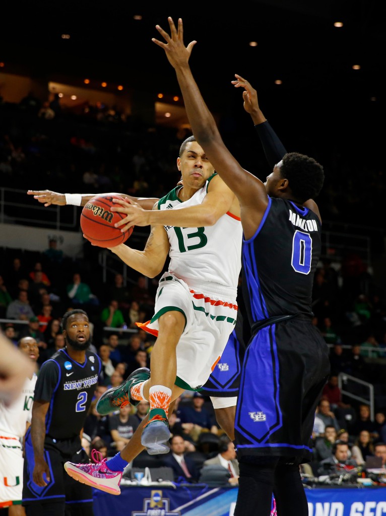 Mar 17, 2016; Providence, RI, USA; Miami Hurricanes guard Angel Rodriguez (13) drives against Buffalo Bulls guard Blake Hamilton (0) during the first half of a first round game of the 2016 NCAA Tournament at Dunkin Donuts Center. Mandatory Credit: Winslow Townson-USA TODAY Sports