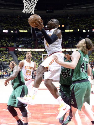 Apr 16, 2016; Atlanta, GA, USA; Atlanta Hawks forward Paul Millsap (4) drives to the basket against Boston Celtics center Kelly Olynyk (41) and forward Amir Johnson (90) during the second half in game one of the first round of the NBA Playoffs at Philips Arena. Mandatory Credit: John David Mercer-USA TODAY Sports