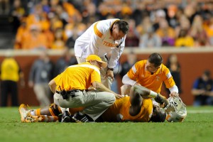 Oct 25, 2014; Knoxville, TN, USA; Tennessee Volunteers head coach Butch Jones check on an injured defensive lineman Trevarris Saulsberry (96) against the Alabama Crimson Tide during the second half at Neyland Stadium. Alabama won 34 to 20. Mandatory Credit: Randy Sartin-USA TODAY Sports