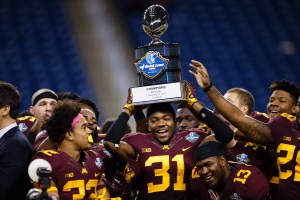 Dec 28, 2015; Detroit, MI, USA; Minnesota Golden Gophers defensive back Eric Murray (31) hold up the trophy after winning the Quick Lane Bowl against the Central Michigan Chippewas at Ford Field. Minnesota won 21-14. Mandatory Credit: Sage Osentoski-USA TODAY Sports