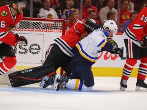 Apr 17, 2016; Chicago, IL, USA; Chicago Blackhawks goalie Corey Crawford (50) checks St. Louis Blues defenseman Carl Gunnarsson (4) during the second period in game three of the first round of the 2016 Stanley Cup Playoffs at the United Center. Mandatory Credit: Dennis Wierzbicki-USA TODAY Sports