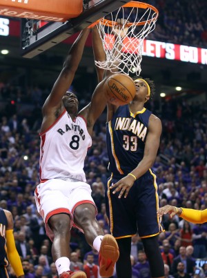 Apr 18, 2016; Toronto, Ontario, CAN; Toronto Raptors center Bismack Biyombo (8) dunks the ball against Indiana Pacers forward Myles Turner (33) in game two of the first round of the 2016 NBA Playoffs at Air Canada Centre. The Raptors beat the Pacers 98-87. Mandatory Credit: Tom Szczerbowski-USA TODAY Sports