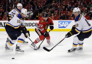 St. Louis Blues right wing Scottie Upshall (10), center Jori Lehtera (12) and Chicago Blackhawks left wing Artemi Panarin (72) go for the puck during the first period in game four of the first round of the 2016 Stanley Cup Playoffs at United Center. Mandatory Credit: David Banks-USA TODAY Sports