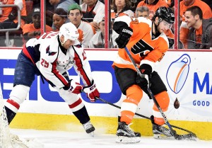 Apr 20, 2016; Philadelphia, PA, USA; Washington Capitals left wing Jason Chimera (25) reaches for the puck as Philadelphia Flyers defenseman Shayne Gostisbehere (53) defends during the third period in game four of the first round of the 2016 Stanley Cup Playoffs at Wells Fargo Center. The Flyers won 2-1. Mandatory Credit: Eric Hartline-USA TODAY Sports