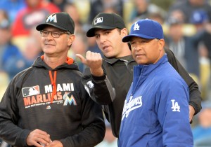Apr 25, 2016; Los Angeles, CA, USA; Miami Marlins manager Don Mattingly (left), umpire Pat Hoberg (center) and Los Angeles Dodgers manager Dave Roberts (30) during a MLB game at Dodger Stadium. Mandatory Credit: Kirby Lee-USA TODAY Sports