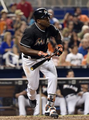 May 21, 2016; Miami, FL, USA; Miami Marlins center fielder Marcell Ozuna (13) connects for a triple during the sixth inning against the Washington Nationals at Marlins Park. Mandatory Credit: Steve Mitchell-USA TODAY Sports