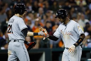 Jun 28, 2016; Detroit, MI, USA; Miami Marlins Adeiny Hechavarria (3) receives congratulations from left fielder Christian Yelich (21) after scoring in the eighth inning against the Detroit Tigers at Comerica Park. Mandatory Credit: Rick Osentoski-USA TODAY Sports