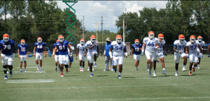 Gator football players warming up before Monday's practice