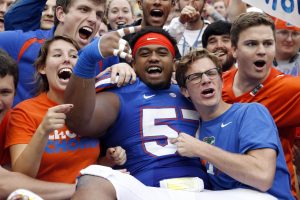 Nov 22, 2014; Gainesville, FL, USA; Florida Gators defensive lineman Caleb Brantley (57) jumps into the stands with fans after they beat the Eastern Kentucky Colonels at Ben Hill Griffin Stadium. Florida Gators defeated the Eastern Kentucky Colonels 52-3. Mandatory Credit: Kim Klement-USA TODAY Sports