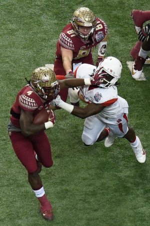 Dec 31, 2015; Atlanta, GA, USA; Florida State Seminoles running back Dalvin Cook (4) carries the ball as Houston Cougars Houston Cougars linebacker Steven Taylor (41) defends during the first quarter in the 2015 Chick-fil-A Peach Bowl at the Georgia Dome. Mandatory Credit: Dale Zanine-USA TODAY Sports