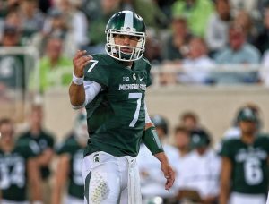 Sep 2, 2016; East Lansing, MI, USA; Michigan State Spartans quarterback Tyler O'Connor (7) gestures from the field during the first half against the Furman Paladins at Spartan Stadium. Mandatory Credit: Mike Carter-USA TODAY Sports