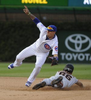 Sep 4, 2016; Chicago, IL, USA; Chicago Cubs third baseman Javier Baez (9) tags out San Francisco Giants center fielder Gorkys Hernandez (66) attempting to steal a base in the twelfth inning of their game at Wrigley Field. Mandatory Credit: Matt Marton-USA TODAY Sports