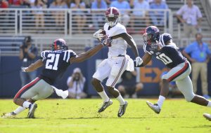 Sep 17, 2016; Oxford, MS, USA; Mississippi Rebels linebacker Terry Caldwell (21) and defensive end Marquis Haynes (10) attempt to tackle Alabama Crimson Tide wide receiver Calvin Ridley (3) during the second quarter of the game against the Alabama Crimson Tide at Vaught-Hemingway Stadium. Alabama won 48-43. Mandatory Credit: Matt Bush-USA TODAY Sports