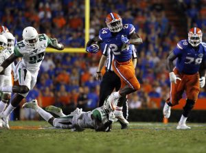 Sep 17, 2016; Gainesville, FL, USA; Florida Gators running back Mark Thompson (24) carries the ball over North Texas Mean Green defensive back James Gray (21) during the second half at Ben Hill Griffin Stadium. Florida Gators defeated the North Texas Mean Green 32-0. Mandatory Credit: Kim Klement-USA TODAY Sports