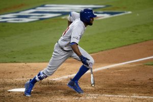 Oct 20, 2016; Los Angeles, CA, USA; Chicago Cubs center fielder Dexter Fowler (24) connects for a RBI single in the eighth inning against the Los Angeles Dodgers in game five of the 2016 NLCS playoff baseball series against the Los Angeles Dodgers at Dodger Stadium. Mandatory Credit: Gary A. Vasquez-USA TODAY Sports