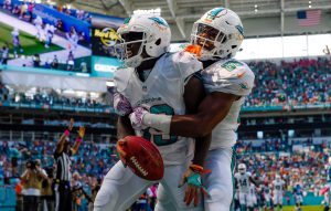 Oct 9, 2016; Miami Gardens, FL, USA; Miami Dolphins wide receiver Leonte Carroo (right) celebrates Dolphins wide receiver Jakeem Grant (left) touchdown run during the first half against Tennessee Titans at Hard Rock Stadium. Mandatory Credit: Steve Mitchell-USA TODAY Sports