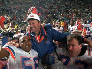 Florida Gators head coach Steve Spurrier is carried on the field by Cameron Davis, 56, and Jim Watson, 73, after the Gators Downed the Alabama Crimson tide 28-3 in the 1993 SEC Football Championship in Birmingham, Ala., Dec.4, 1993. (AP photo/Dave Martin)