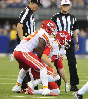 Oct 30, 2016; Indianapolis, IN, USA; Kansas City Chiefs quarterback Alex Smith (11) is helped up by teammate running back Spencer Ware (32) after taking a hard hit in the first half from Indianapolis Colts linebacker Edwin Jackson (53) at Lucas Oil Stadium. Mandatory Credit: Thomas J. Russo-USA TODAY Sports