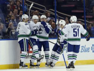 Dec 8, 2016; Tampa, FL, USA; Vancouver Canucks right wing Jack Skille (9) celebrates with teammates after scoring a goal against the Tampa Bay Lightning during the first period at Amalie Arena. Mandatory Credit: Kim Klement-USA TODAY Sports