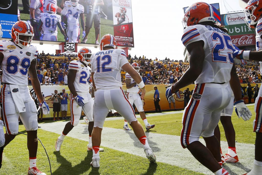 Jan 2, 2017; Tampa , FL, USA; Florida Gators quarterback Austin Appleby (12) celebrates with teammates after scoring a touchdown in the second quarter against the Iowa Hawkeyes at Raymond James Stadium. Mandatory Credit: Logan Bowles-USA TODAY Sports