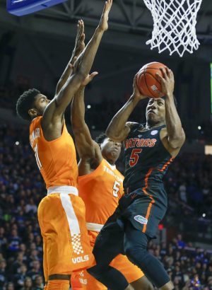 Jan 7, 2017; Gainesville, FL, USA; Florida Gators guard KeVaughn Allen (right) shoots despite block attempts by Tennessee Volunteers forward Kyle Alexander (11) and forward Admiral Schofield (center) during the first half of an NCAA men's basketball game in the Exactech Arena at the Stephen C. O'Connell Center. Mandatory Credit: Reinhold Matay-USA TODAY Sports