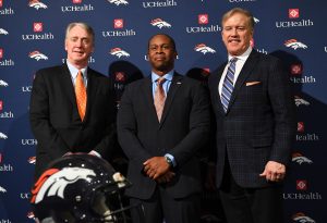 Jan 12, 2017; Englewood, CO, USA; Denver Broncos head coach Vance Joseph (center) and general manager John Elway (right) and president Joe Ellis pose for a photo following a press conference at UCHealth Training Center. Mandatory Credit: Ron Chenoy-USA TODAY Sports