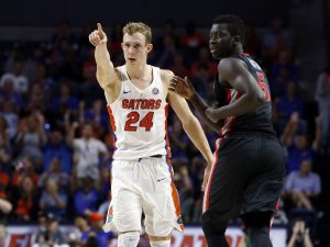 Jan 14, 2017; Gainesville, FL, USA; Florida Gators guard Canyon Barry (24) points as Georgia Bulldogs forward Pape Diatta (5) looks on after he made a there pointer during the first half at Exactech Arena at the Stephen C. O'Connell Ce. Mandatory Credit: Kim Klement-USA TODAY Sports