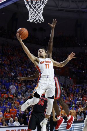 Jan 14, 2017; Gainesville, FL, USA; Florida Gators guard Chris Chiozza (11) drives to the basket past Georgia Bulldogs guard Jordan Harris (2) during the first half at Exactech Arena at the Stephen C. O'Connell Ce. Mandatory Credit: Kim Klement-USA TODAY Sports