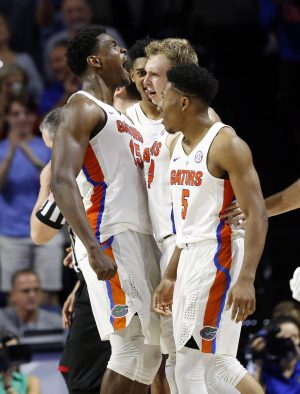 Jan 14, 2017; Gainesville, FL, USA; Florida Gators guard Canyon Barry (24) is congratulated by center John Egbunu (15), and guard KeVaughn Allen (5) after he scores a three pointer and draws a foul during the second half at Exactech Arena at the Stephen C. O'Connell Ce. Mandatory Credit: Kim Klement-USA TODAY Sports