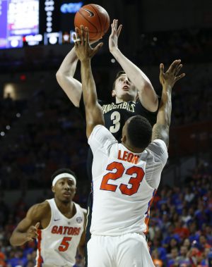 Jan 21, 2017; Gainesville, FL, USA; Vanderbilt Commodores forward Luke Kornet (3) shoots over Florida Gators forward Justin Leon (23) as guard KeVaughn Allen (5) looks on during the first half of an NCAA basketball game at Exactech Arena at the Stephen C. O'Connell Center. Mandatory Credit: Reinhold Matay-USA TODAY Sports