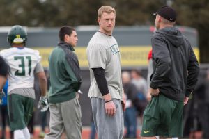 Jan 10, 2015; Euless, TX, USA; Oregon Ducks offensive coordinator Scott Frost (left) and head coach Mark Helfrich (right) watch their team during practice at the Euless Trinity High School football field. Mandatory Credit: Jerome Miron-USA TODAY Sports