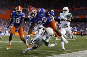 Sep 17, 2016; Gainesville, FL, USA; Florida Gators running back Lamical Perine (22) runs with the ball as North Texas Mean Green defensive back Eric Jenkins (2) defends during the second quarter at Ben Hill Griffin Stadium. Mandatory Credit: Kim Klement-USA TODAY Sports