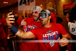 Washington Nationals starting pitcher Max Scherzer, left, and Gerardo Parra celebrate after the second baseball game of a doubleheader against the Philadelphia Phillies, Tuesday, Sept. 24, 2019, in Washington. Washington won 6-5 and clinched a Wild Card berth. (AP Photo/Patrick Semansky)